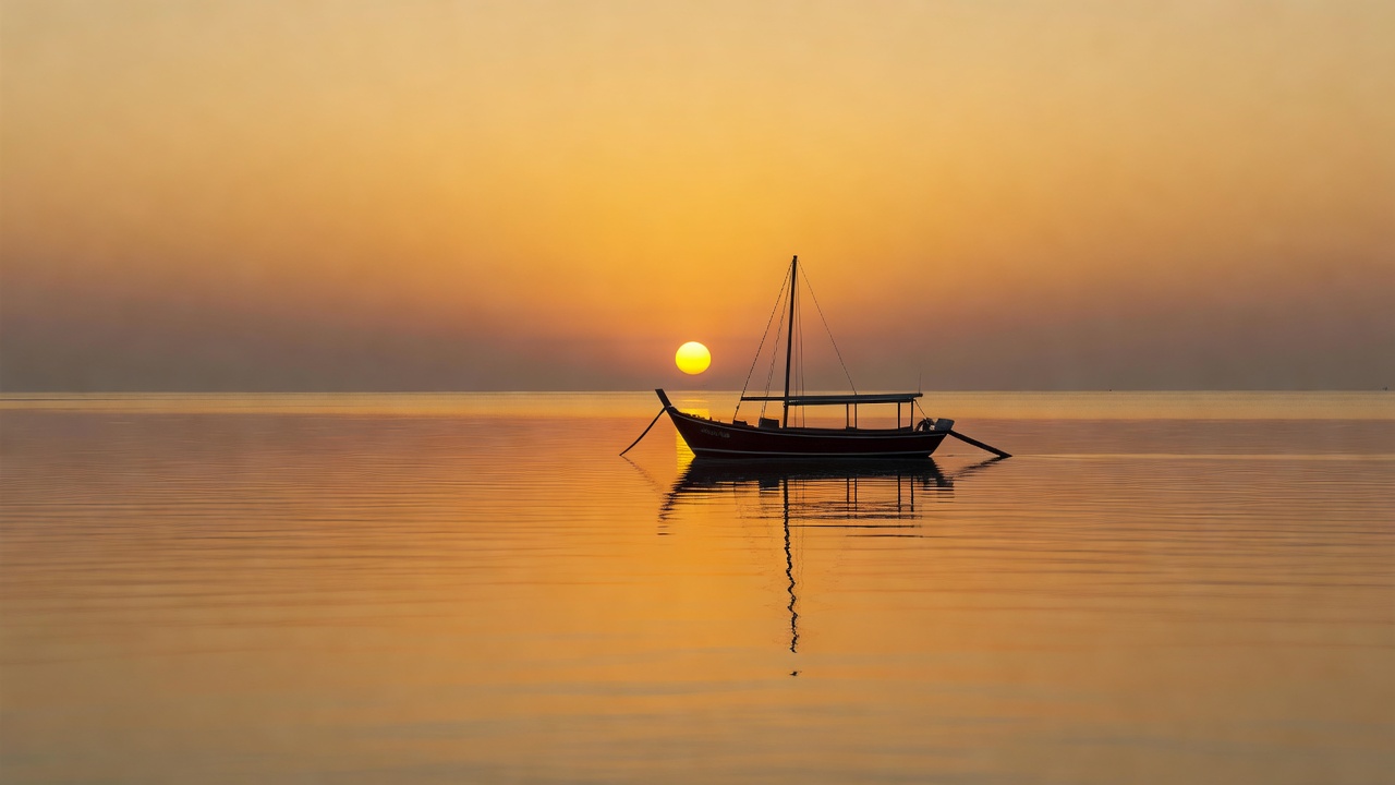 Golden sunset over a calm ocean, representing dhoni sunset cruises